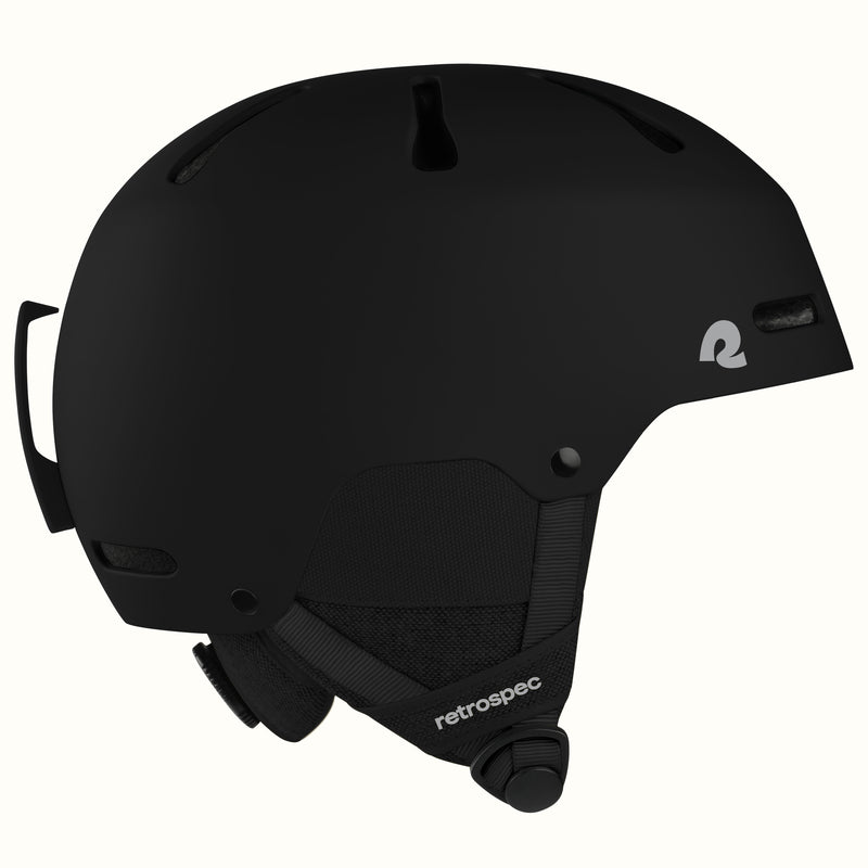 A matte black retrospec ski helmet shown from a side profile view against a clean off-white background.