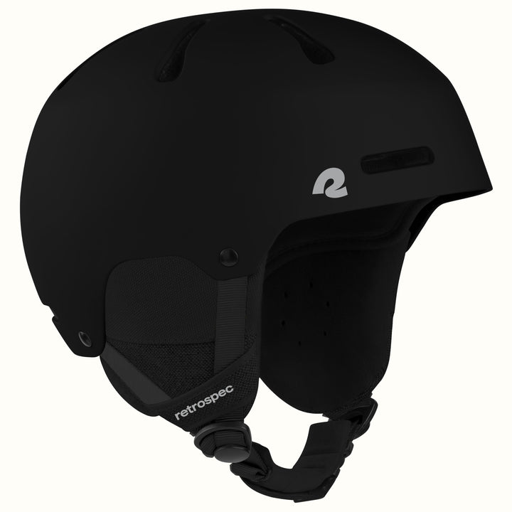 A matte black ski helmet with a white stylized 'r logo on the side and 'retrospec' text on the chin strap, shown against a plain off-white background.