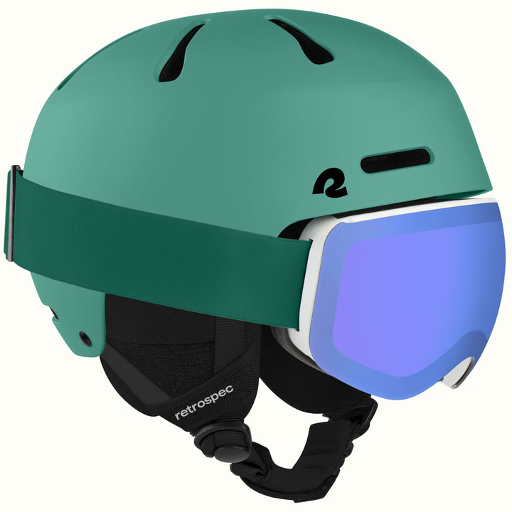 A matte green ski helmet with a matching green head strap and a white-framed ski goggle featuring a blue mirrored lens. The helmet has black vents and a black chin strap with the 'retrospec' brand name visible.