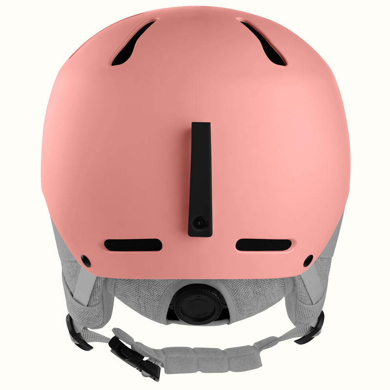 A matte pink ski helmet shown from the back, featuring black ventilation slots, a central black strap attachment, and a gray adjustable chin strap system, set against a plain white background.