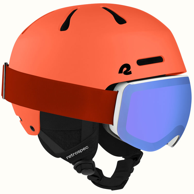 An orange retrospec ski helmet with a matching orange head strap and a blue mirrored ski goggle, shown against a plain white background.
