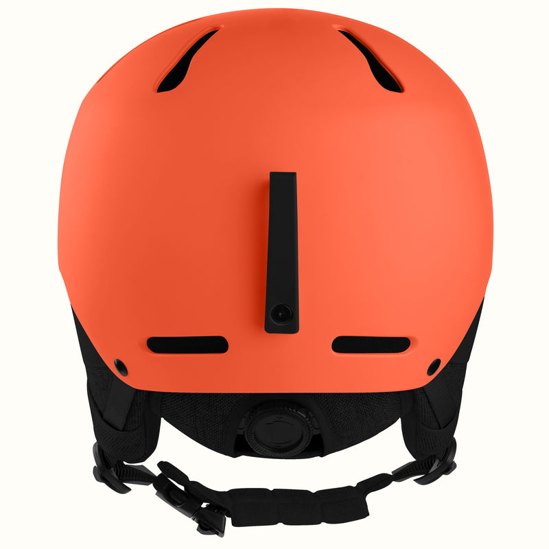 Matte orange ski helmet shown from the back, featuring black ventilation slots, a central vertical vent, and a black adjustable chin strap against a plain white background.