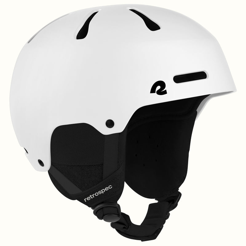 A white ski helmet with black ventilation slots, a black interior padding, and a black chin strap, featuring the 'retrospec' brand name on the strap.