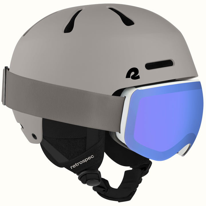 retrospec Comstock ski helmet with goggles in matte canyon, blue mirrored lens goggles clipped to the strap.