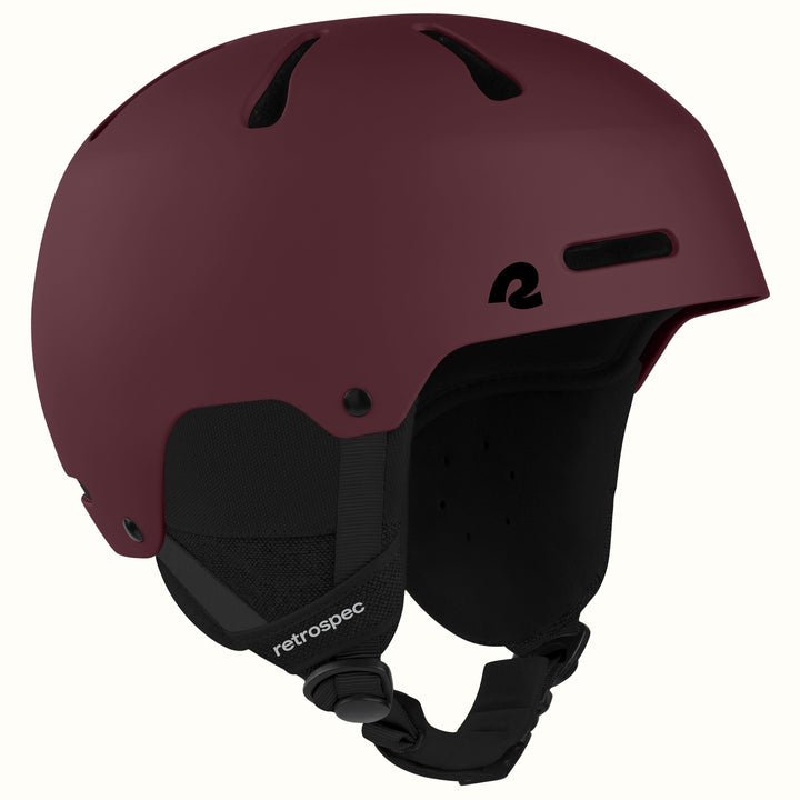 retrospec Comstock snowboard helmet in matte dark burgundy, angled view highlighting top vent channels.