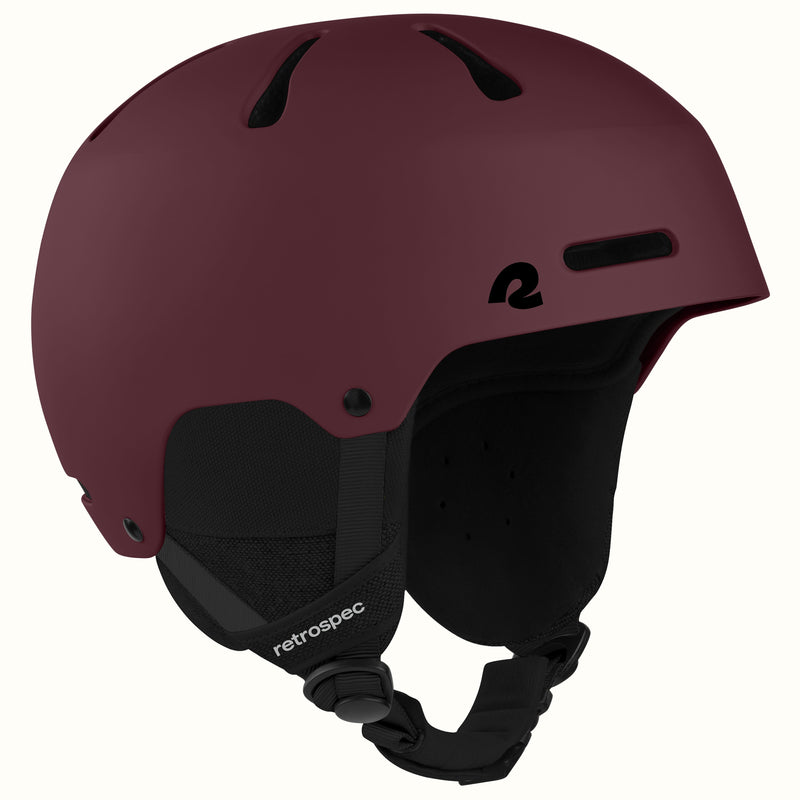 retrospec Comstock snowboard helmet in matte dark burgundy, angled view highlighting top vent channels.