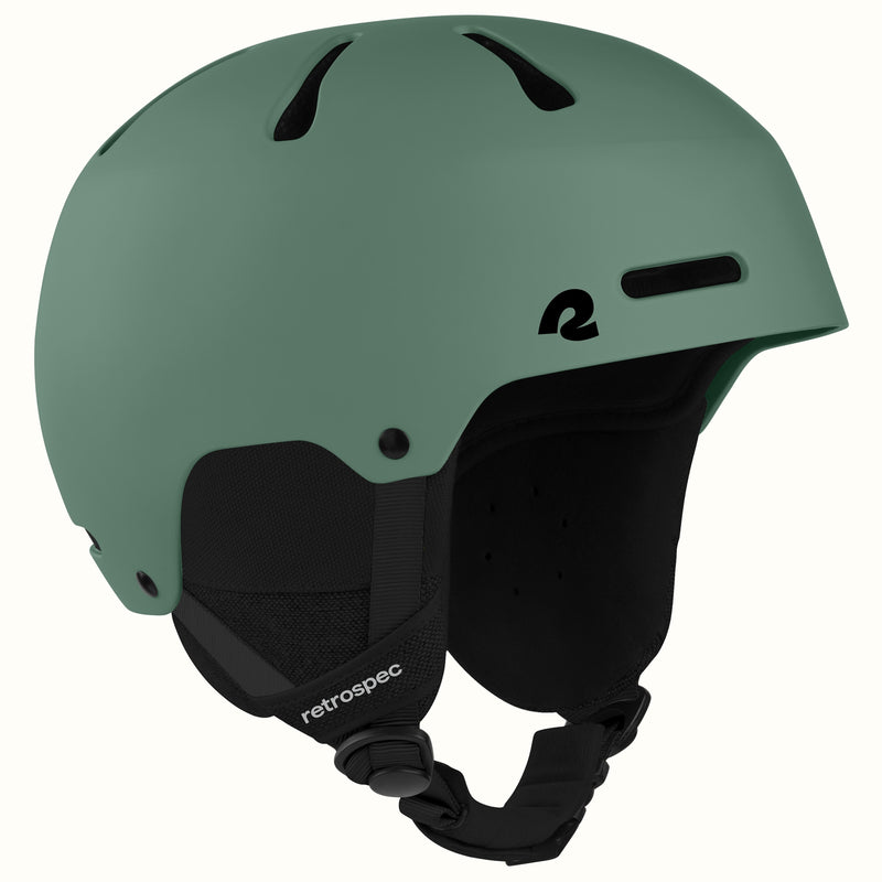 retrospec Comstock snowboard helmet in matte summit grove green, angled view highlighting top vent channels.