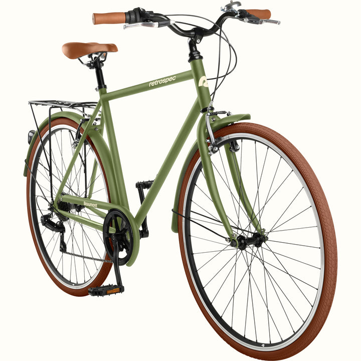 retrospec Beaumont commuter bike in olive green with brown leather grips, rear cargo rack, fenders, and brown-wall tires on a white background.
