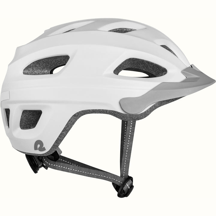 Side view of a Lennon Commuter Bike Helmet in Matte White, showing the ventilation ports, reflective side strip, Retrospec logo, short visor, and adjustable chin strap against a clean background.

