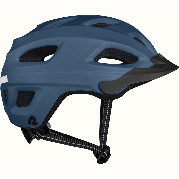 Side view of a Lennon Commuter Bike Helmet in Matte Navy Blue, showing the ventilation ports, reflective side strip, Retrospec logo, short visor, and adjustable chin strap against a clean background.

