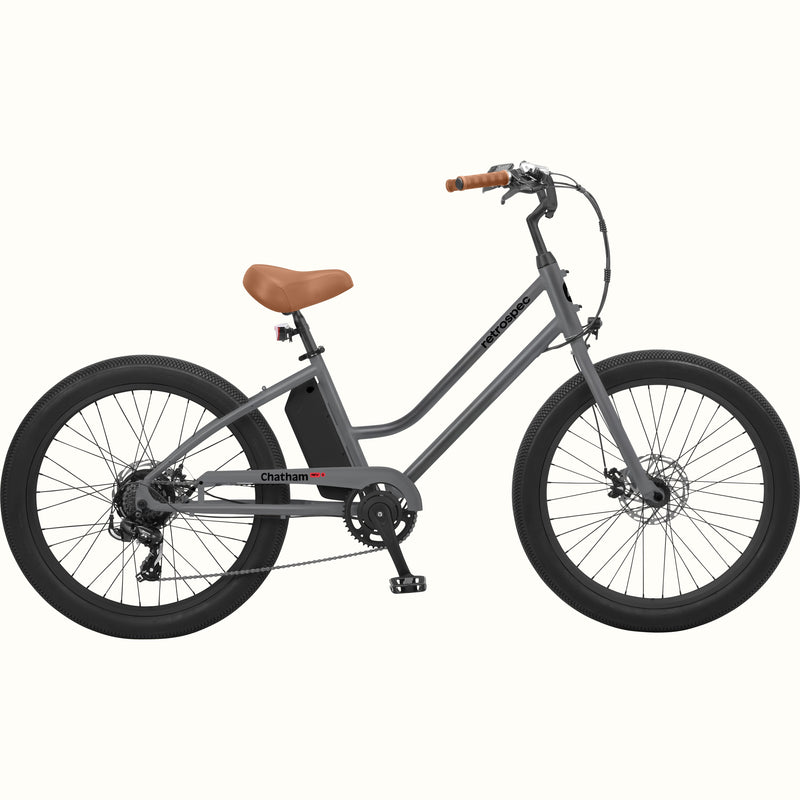 A matte graphite Chatham Rev 3 Beach Cruiser Electric Bike - Step Through with a brown seat, wide tires, and a sleek design, ideal for casual riding.