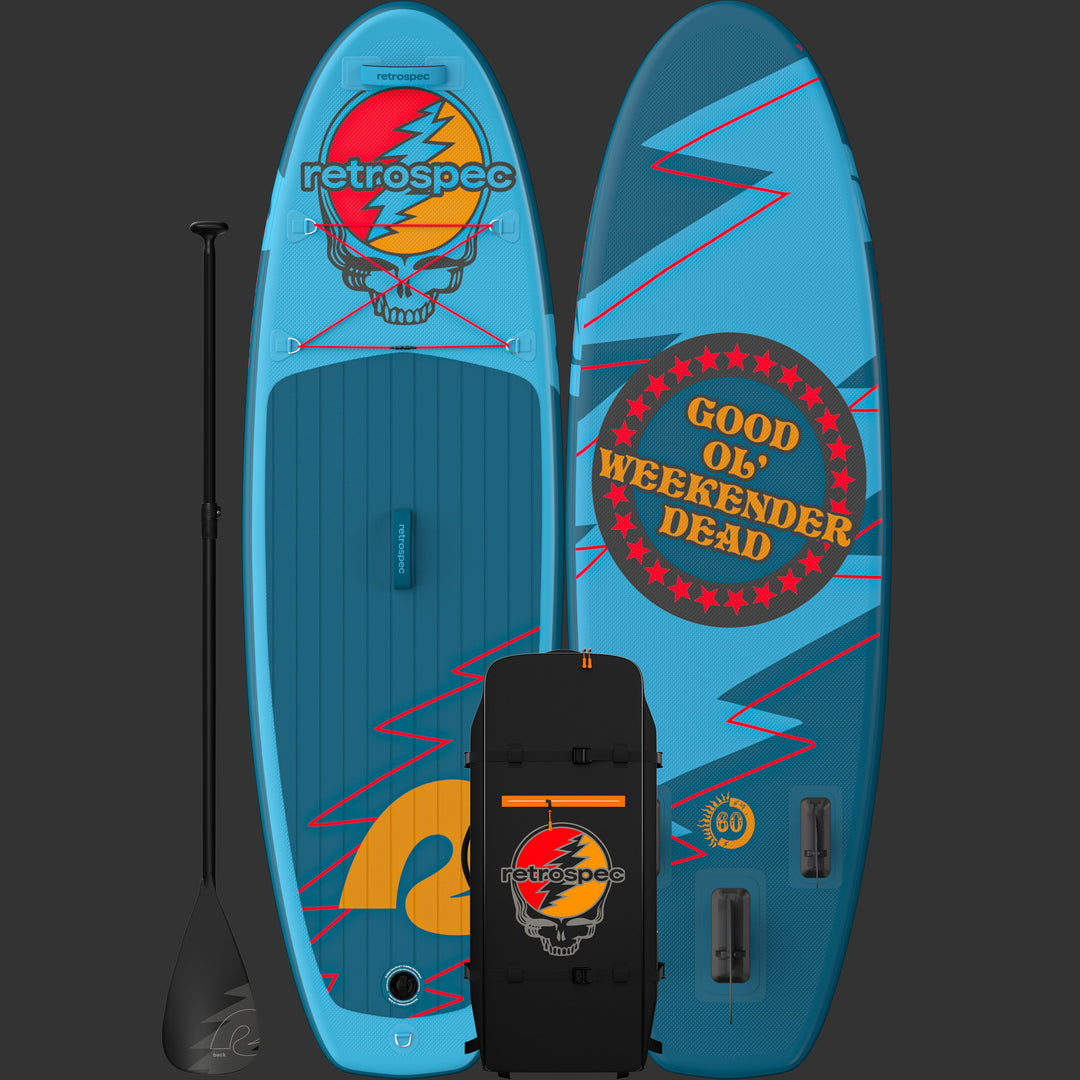 The vibrant Grateful Dead Weekender Nano Kids' Inflatable Paddle Board featuring the Grateful Dead Steal Your Face iconic artwork, a retrospec bright orange logo, and red lightning bolt designs with red bungee cords and a textured surface for grip, alongside a paddle a sleek black carry bag.

