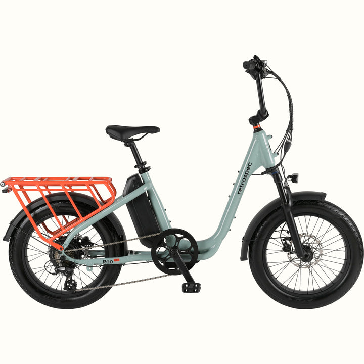 Mint green electric bike with a cargo rack on a white background.