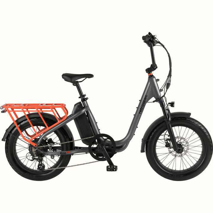 Gray electric bike with an orange cargo rack on a white background.