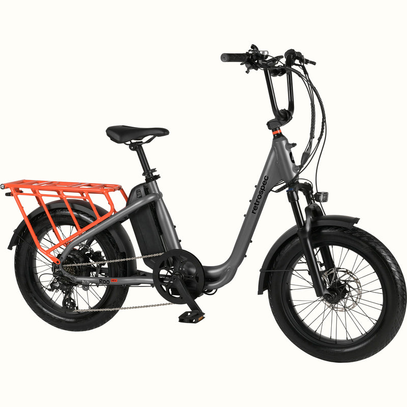 Gray electric bike with an orange cargo rack on a white background.