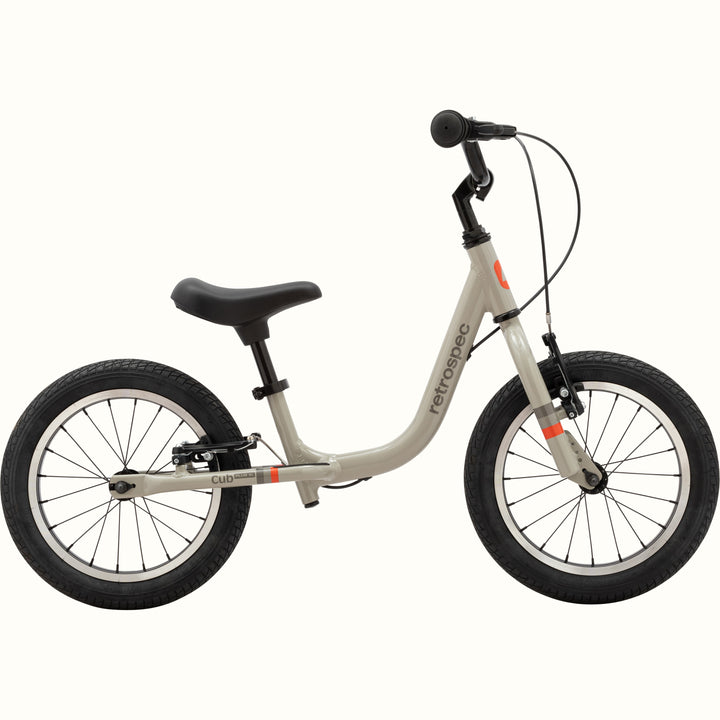 A gray balance bike with black wheels and seat, no pedals, branded "Retrospec."