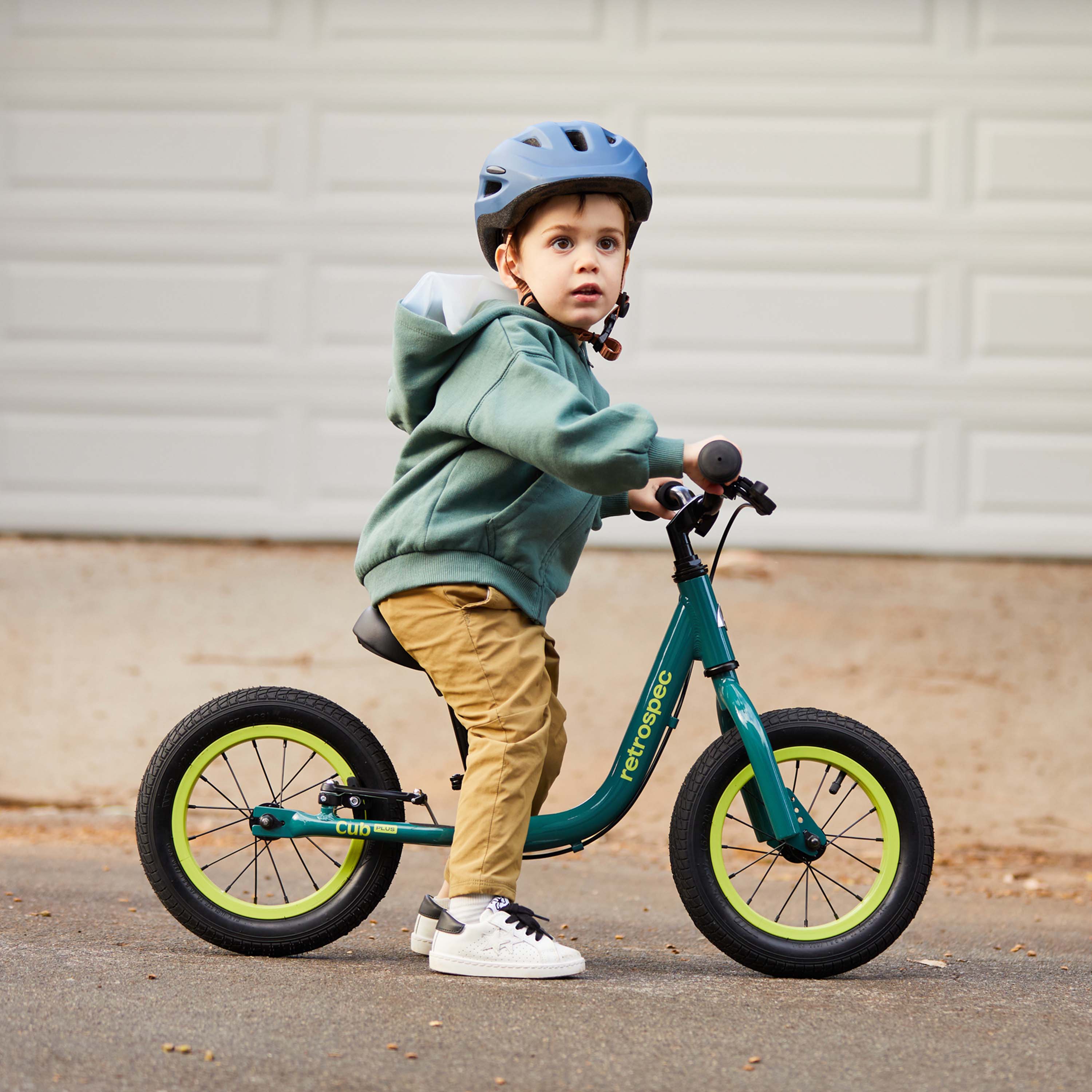 Kid riding balance bike online