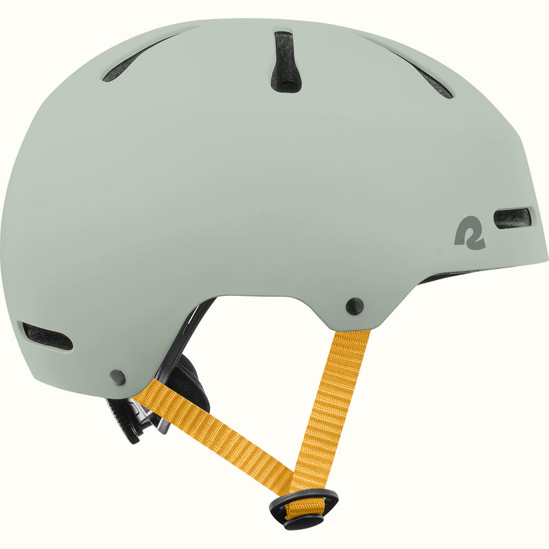 Side profile of the retrospec Dakota youth helmet in matte sage green with vents and mustard yellow side straps.