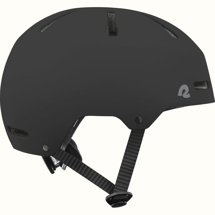 Side profile of the retrospec Dakota black bike helmet for kids with a matte finish, top vents, and black side straps.