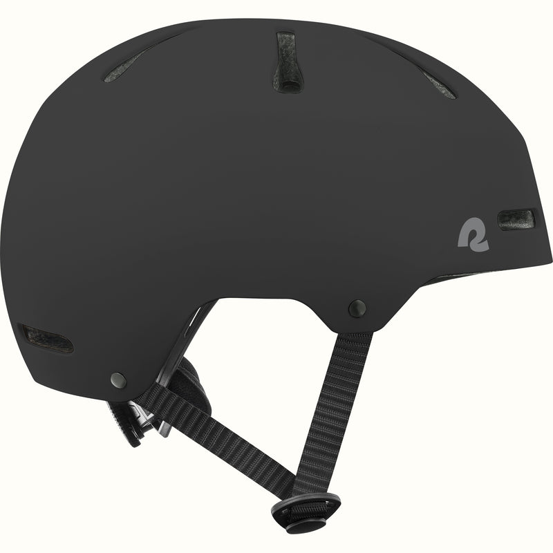 Side profile of the retrospec Dakota black bike helmet for kids with a matte finish, top vents, and black side straps.