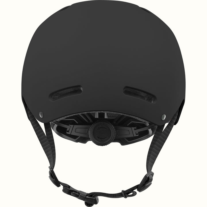 Back of the retrospec Dakota kids skateboard helmet in matte black showing rear vents and a dial fit adjustment system.