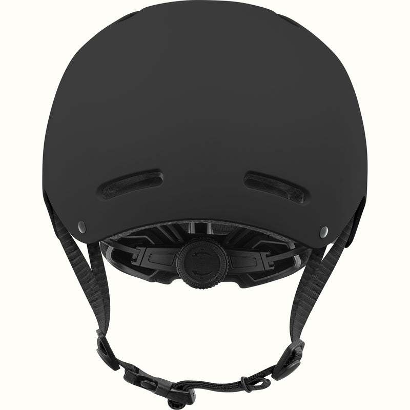 Back of the retrospec Dakota kids skateboard helmet in matte black showing rear vents and a dial fit adjustment system.
