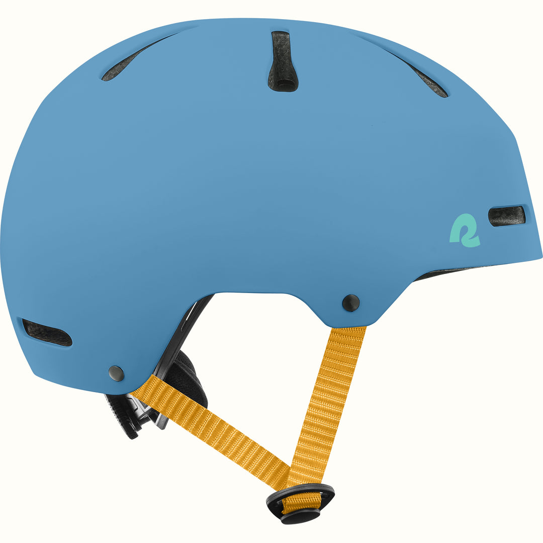 Side profile of the retrospec Dakota blue bike helmet for kids with a matte finish, vents, and golden yellow side straps.