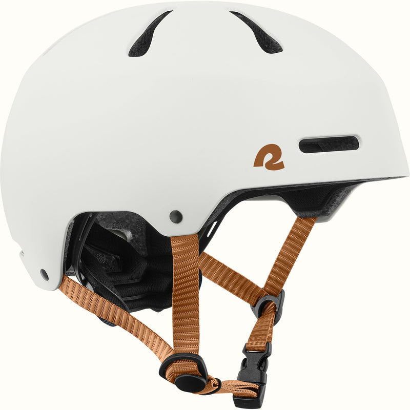 A white skate helmet with black vents, a brown logo on the side, and brown adjustable chin straps, shown against a plain white background.