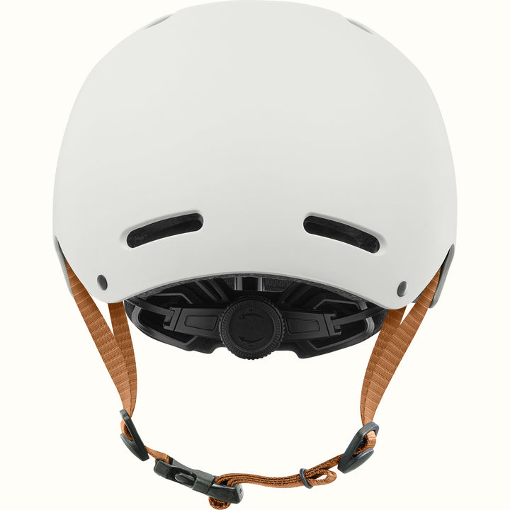 White bike and skate helmet with a black dial closure system and brown adjustable chin straps, shown from the back on a white background.