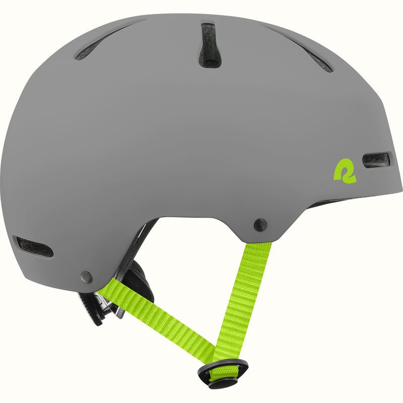 Side profile of the retrospec Dakota gray bike helmet for kids with a matte finish, vents, and lime green side straps.
