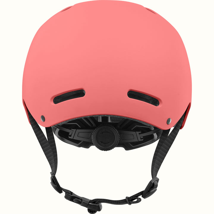 Rear view of the retrospec Dakota kids helmet in coral pink with two back vents and a black fit dial.