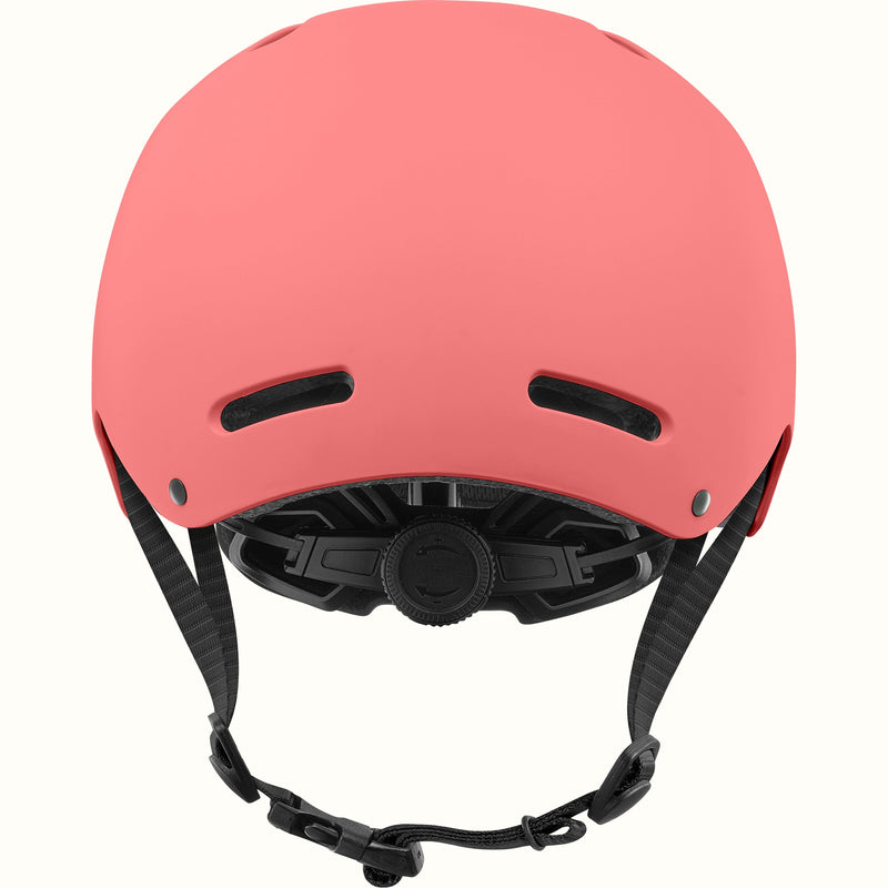 Rear view of the retrospec Dakota kids helmet in coral pink with two back vents and a black fit dial.
