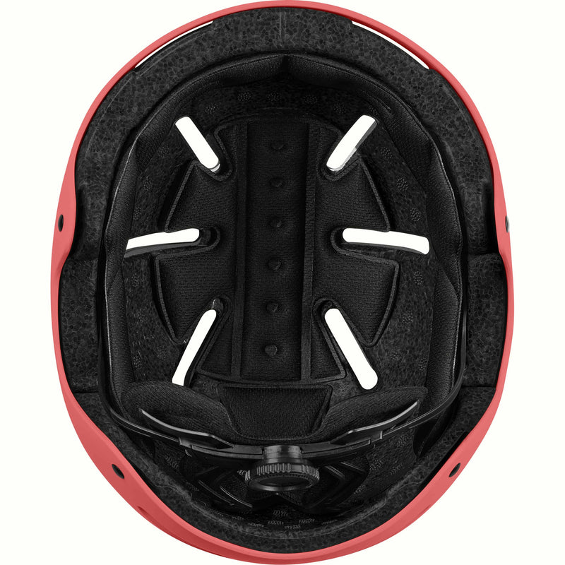 Interior of the retrospec Dakota youth helmet showing a black padded liner, vent channels, and fit dial inside a coral shell.