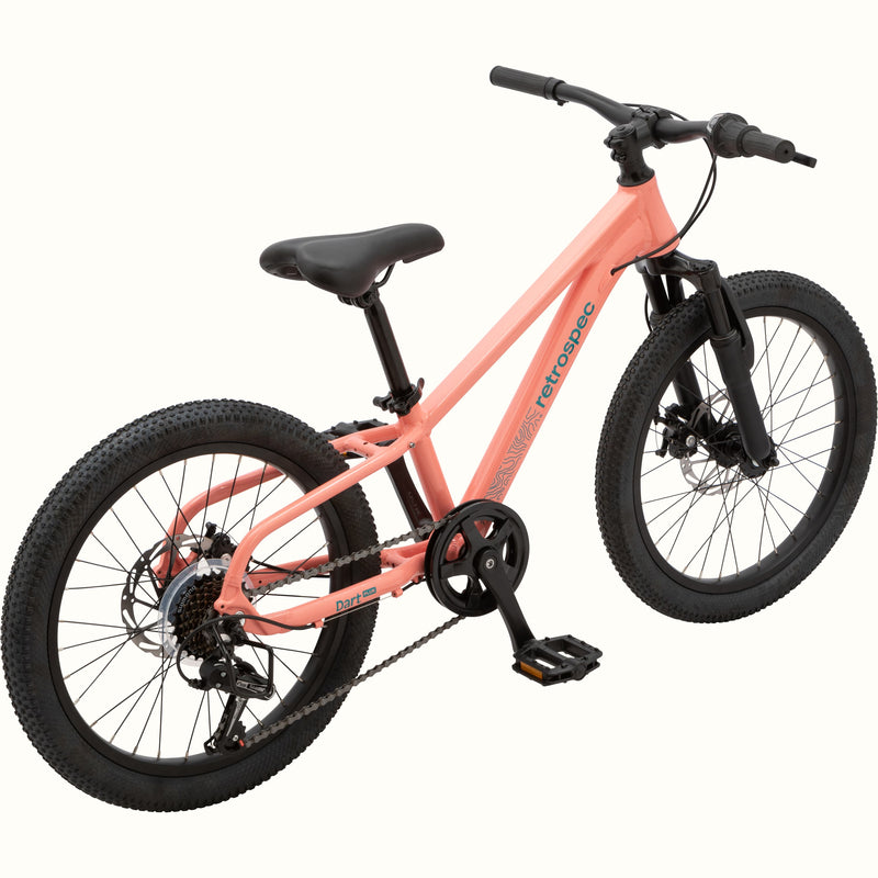 View of the Dart Plus 20" Kids' Bike in Fairy Floss Pink color with blue-gray branded "retrospec" and "Dart Plus" logos on the frame, and thick black tires isolated on a white background.