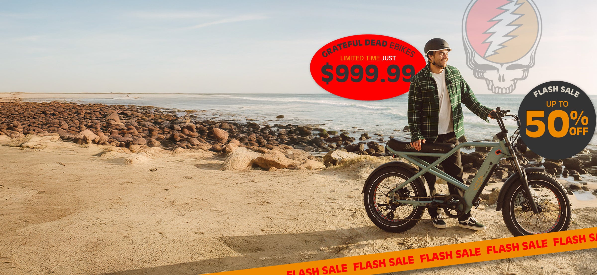 A person stands next to a Grateful Dead-themed e-bike on a rocky beach, promoting a flash sale with discounts and pricing visible.