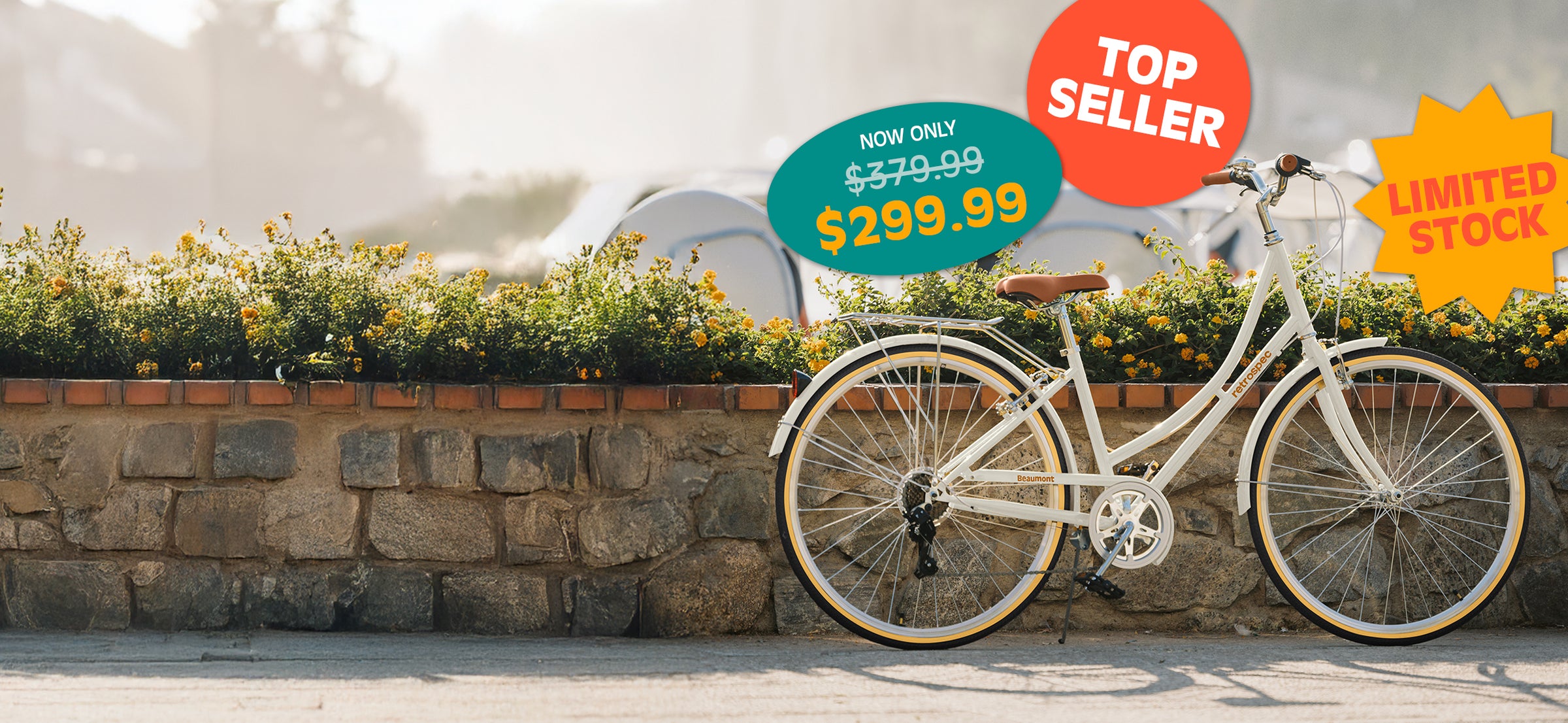 White retro-style bicycle displayed outdoors with price tags indicating a discounted $299.99 sale, labeled as top seller and limited stock.