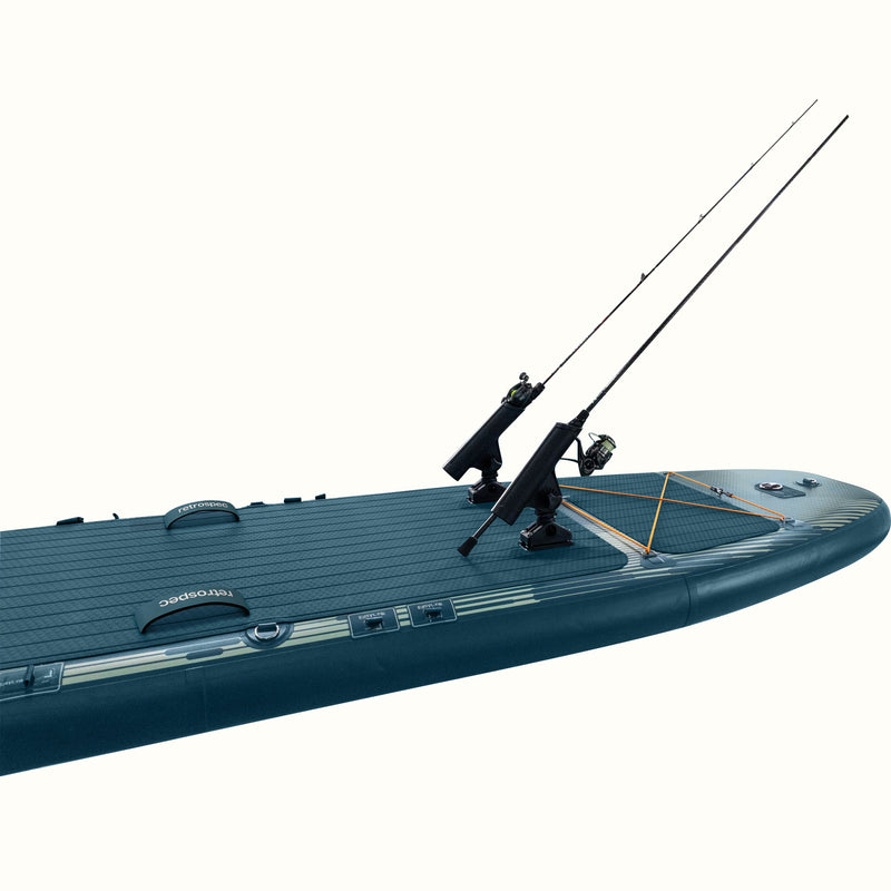 Inflatable paddleboard equipped with two fishing rod holders, carrying handles, and bungee cord storage on the front deck.