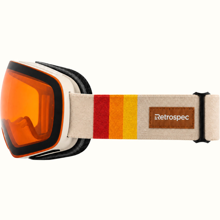 Side view of retrospec Traverse Plus goggles with a cream strap, red, orange, and yellow stripes, and brown logo patch.