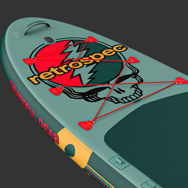 A close up of the Grateful Dead Weekender Plus Inflatable Paddle Board featuring the iconic "Steal Your Face" or "SYF" design and red bungee for storage.