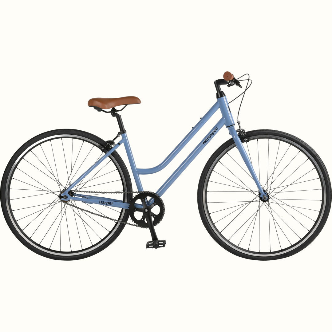 Light blue single speed city bicycle with black wheels, brown saddle, and no visible gears.