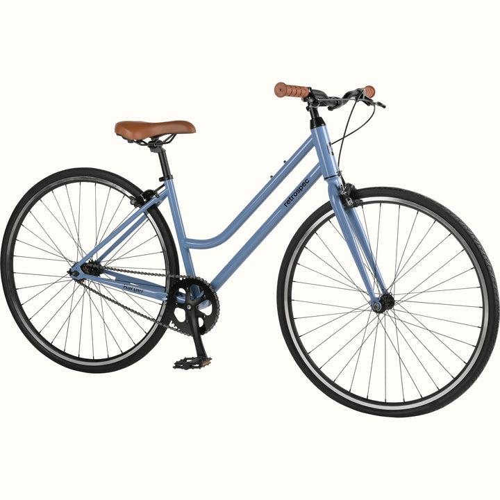 A light blue single speed fixie bicycle with a brown saddle and handlebar grips.