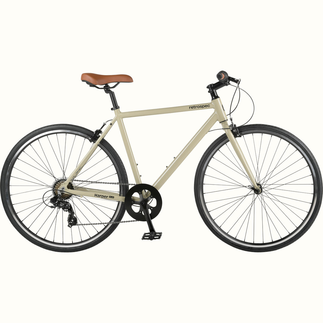 A cream-colored retrospec Harper Plus 7-Speed bicycle with brown saddle and black details.