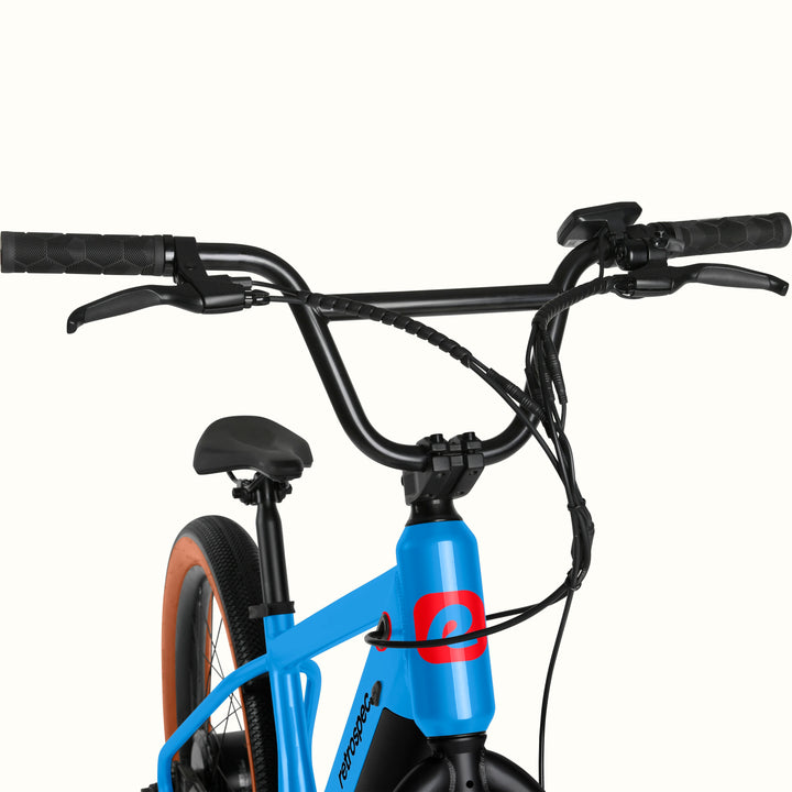 Close-up of the blue Joe Rev 2 BMX Electric Bike with handlebars and seat on a white background.