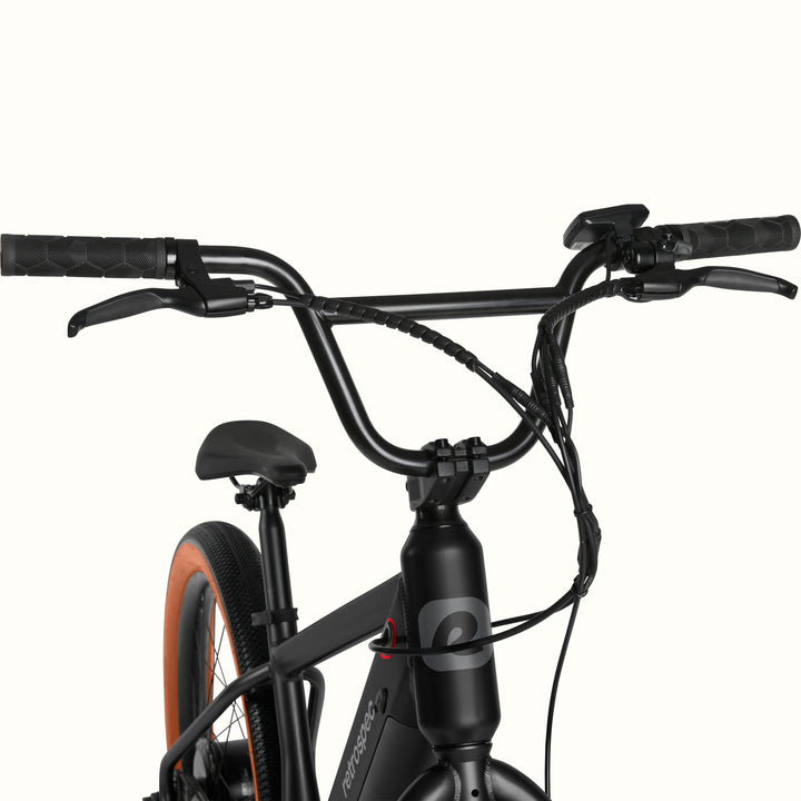 Close-up of the black Joe Rev 2 BMX Electric Bike with handlebars and seat on a white background.