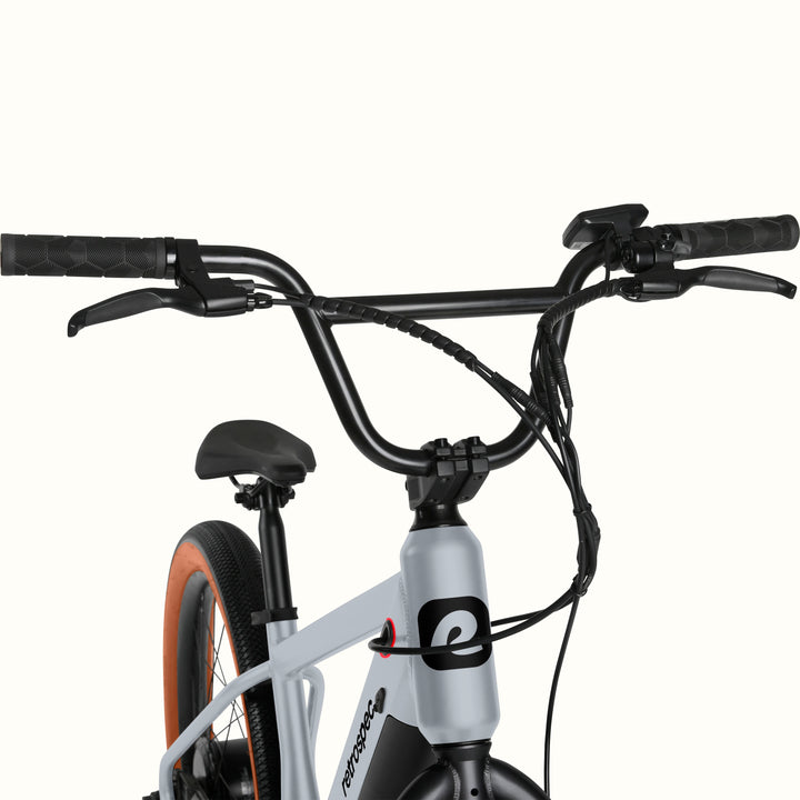 Close-up of the gray Joe Rev 2 BMX Electric Bike with handlebars and seat on a white background.