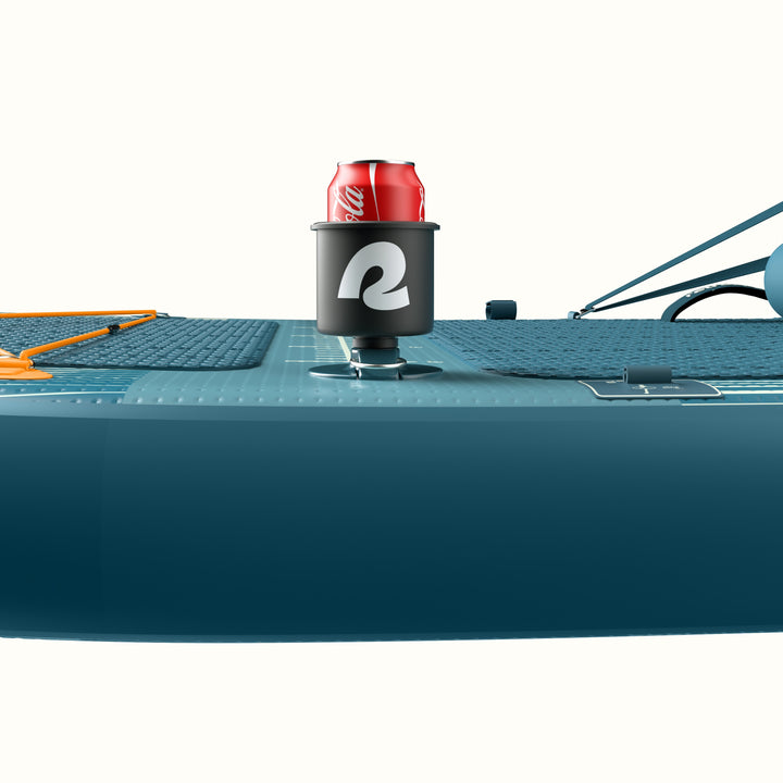 Close-up of the retrospec June Inflatable Fishing Paddle Board Kayak Hybrid 11’6” in River Rock Blue showing the mounted retrospec DrinkLink cup holder with a can inserted, alongside the orange bungee cargo lacing and textured deck pad.
