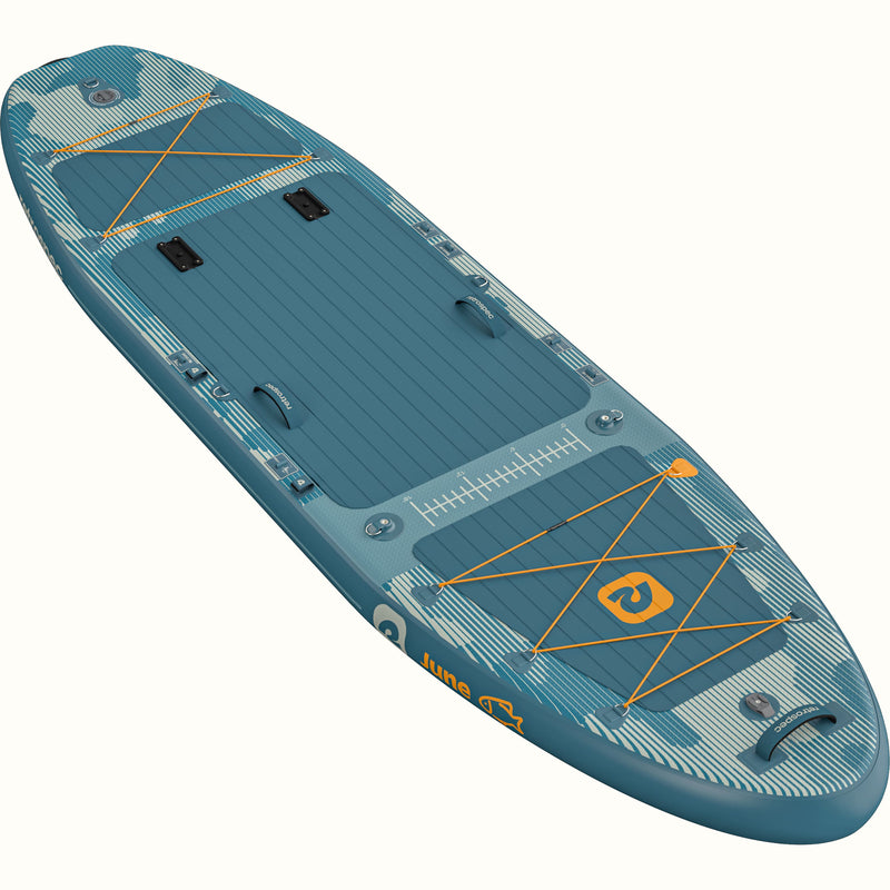 A blue June Inflatable Fishing Paddle Board Kayak Hybrid with bungee cords and a logo on the deck.