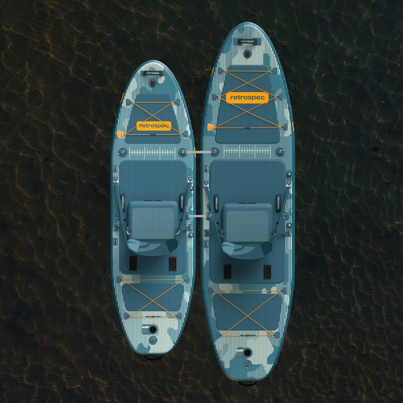 An aerial view of the June Inflatable Fishing Paddle Board Kayak Hybrid 11’6” and June Nano Kids’ Inflatable Fishing Paddle Board Kayak Hybrid tethered together on a calm body of water.