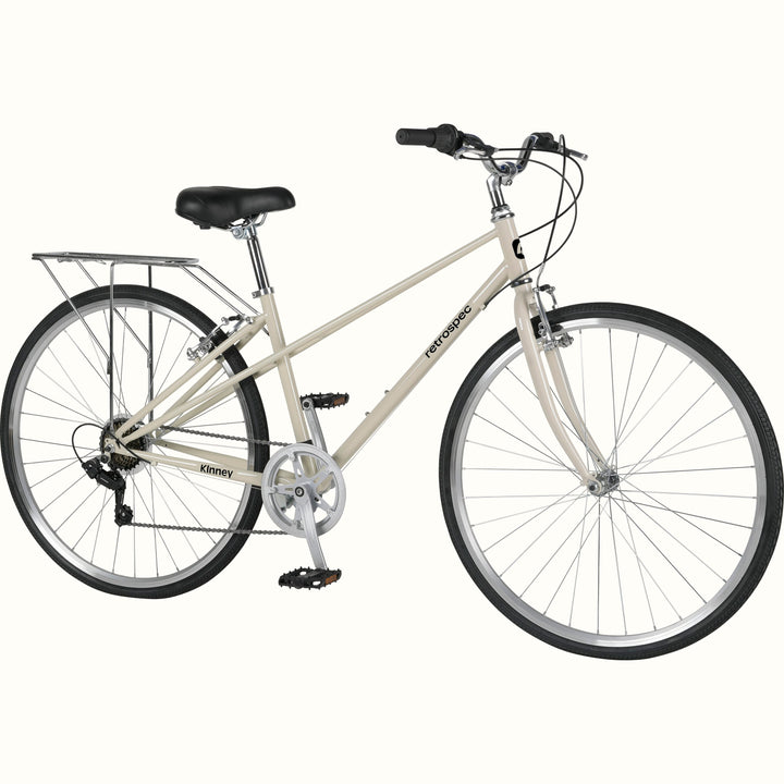 A vintage-style Kinney Mixte City Bike - 7 Speed in white with black accents, featuring a classic frame, padded seat, and a rear rack for carrying items.