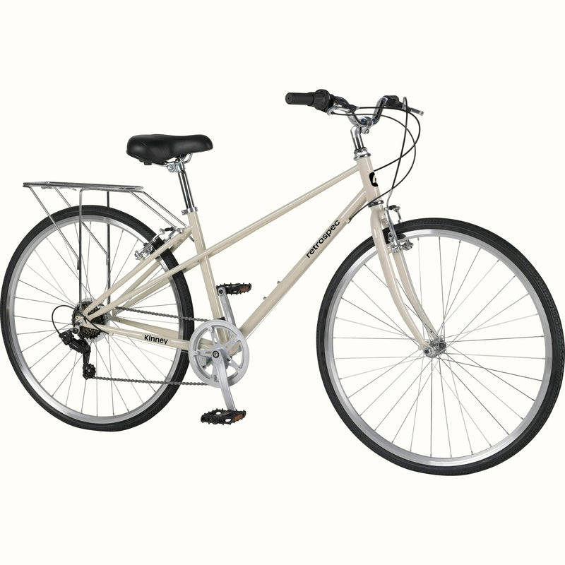 A vintage-style Kinney Mixte City Bike - 7 Speed in white with black accents, featuring a classic frame, padded seat, and a rear rack for carrying items.